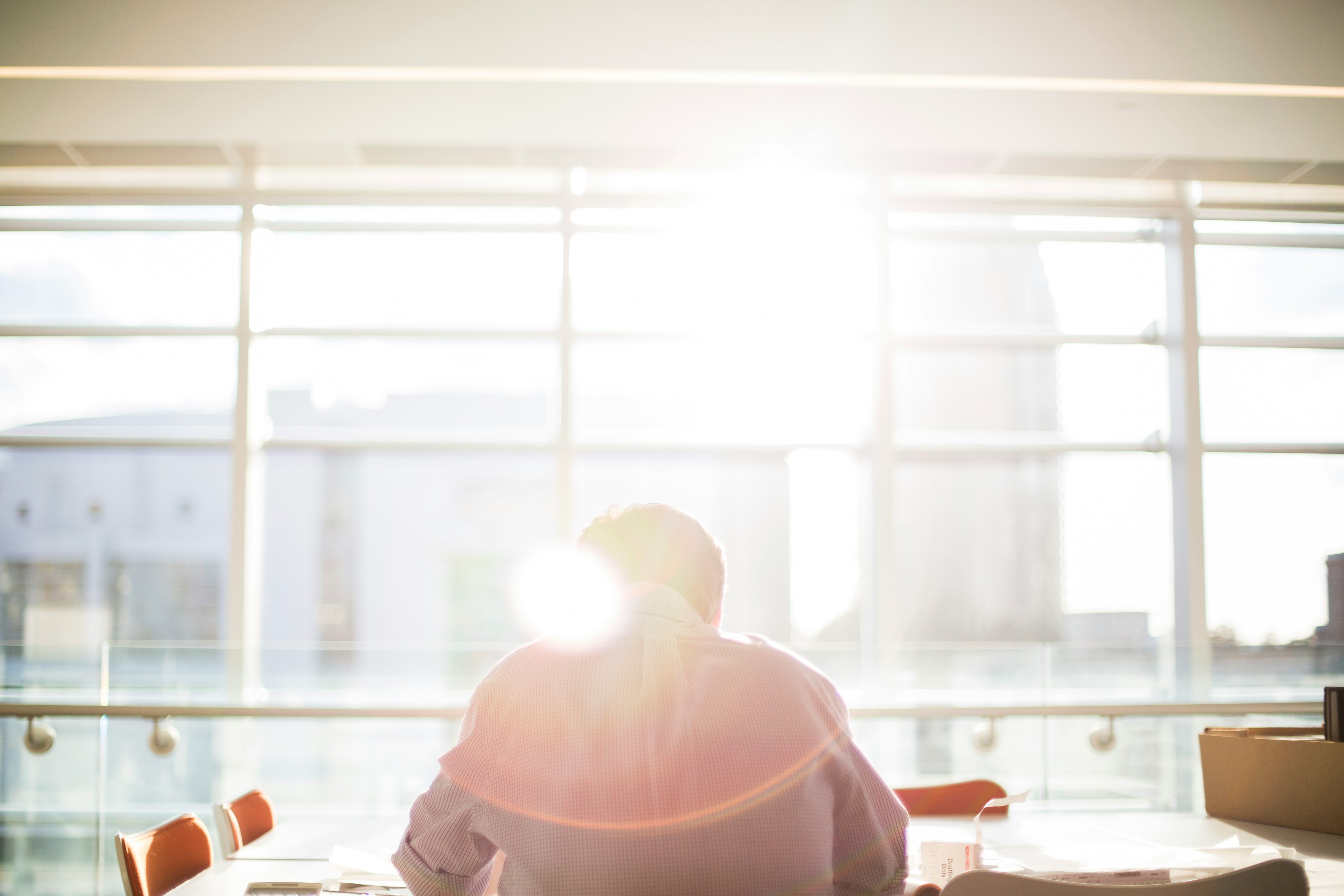 Attorney sitting at a desk near a window in sunlight. 